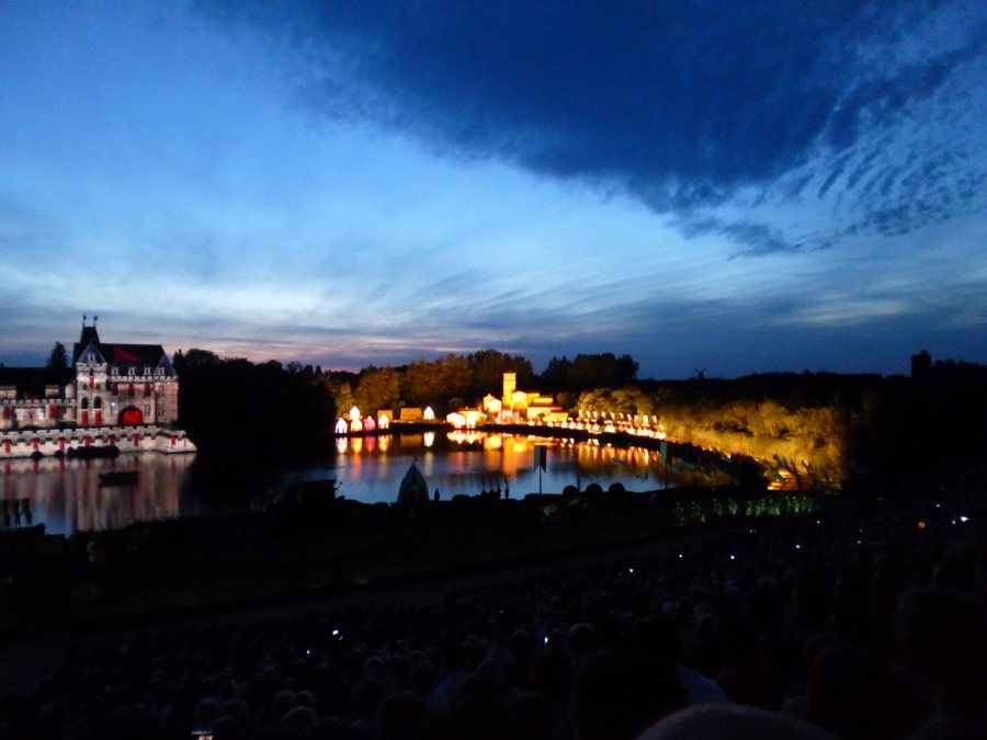 A huge village is lit up from nowhere in Cinescenie at Puy du Fou
