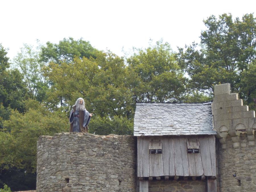 Merlin appears at the top of a castle at Puy du Fou in the Knights of the round table show